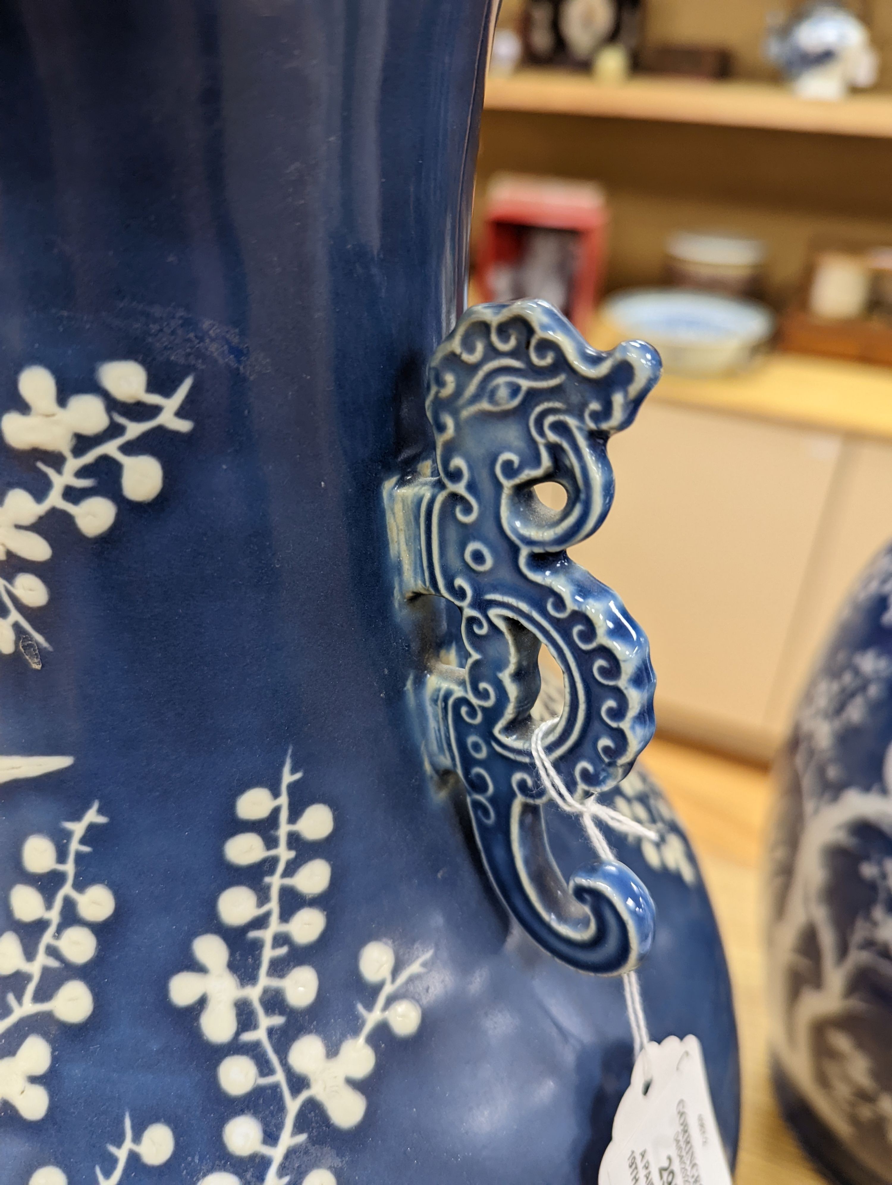 A pair of large 19th century Chinese slip decorated blue ground vases, restored, 59cm